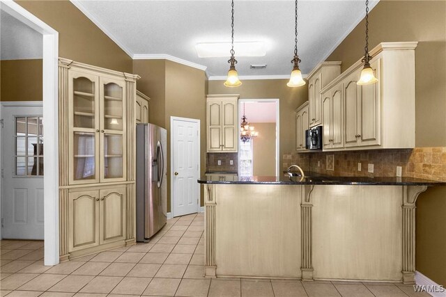 kitchen with light tile patterned floors, a peninsula, stainless steel fridge with ice dispenser, a kitchen breakfast bar, and cream cabinets