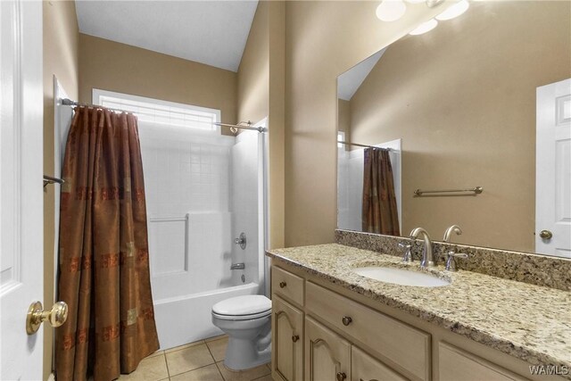 bathroom featuring tile patterned floors, shower / tub combo, toilet, and vanity