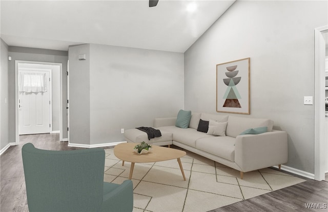 living room featuring hardwood / wood-style floors and vaulted ceiling