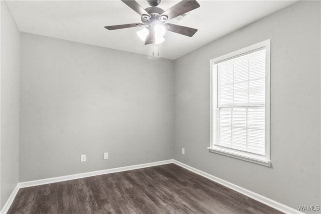 spare room featuring dark hardwood / wood-style flooring, ceiling fan, and a healthy amount of sunlight