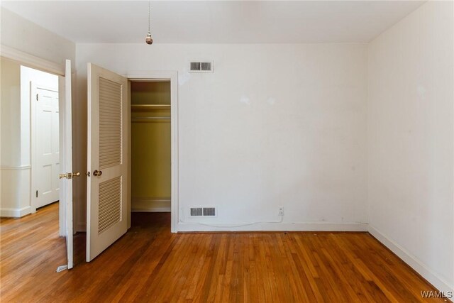 9C Country Club Hls, Tuscaloosa, AL 35401 - unfurnished bedroom featuring wood finished floors, baseboards, and a closet