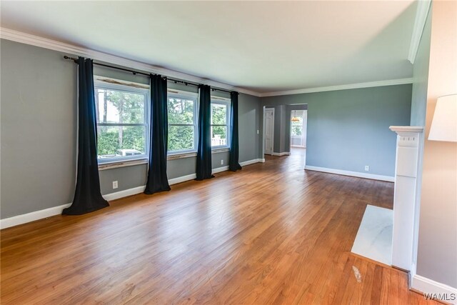 9C Country Club Hls, Tuscaloosa, AL 35401 - unfurnished living room featuring ornamental molding, baseboards, and wood finished floors