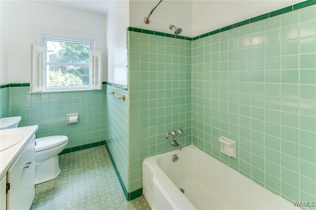 9C Country Club Hls, Tuscaloosa, AL 35401 - full bath featuring toilet, tile patterned floors, vanity, tile walls, and wainscoting