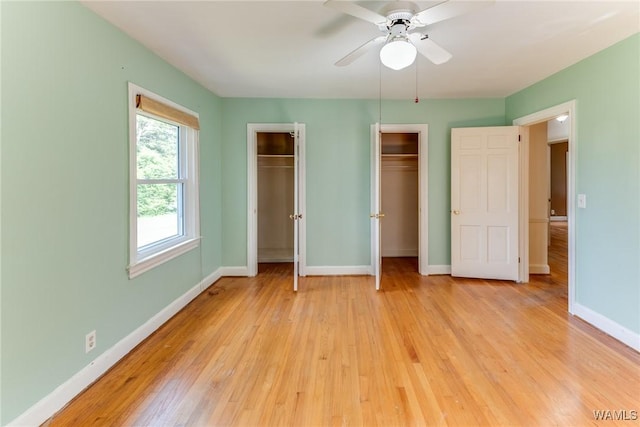 9C Country Club Hls, Tuscaloosa, AL 35401 - unfurnished bedroom with two closets, baseboards, light wood-style flooring, and a ceiling fan