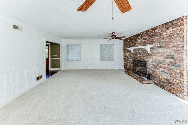 9C Country Club Hls, Tuscaloosa, AL 35401 - unfurnished living room with ceiling fan, a fireplace, carpet, wainscoting, and brick wall