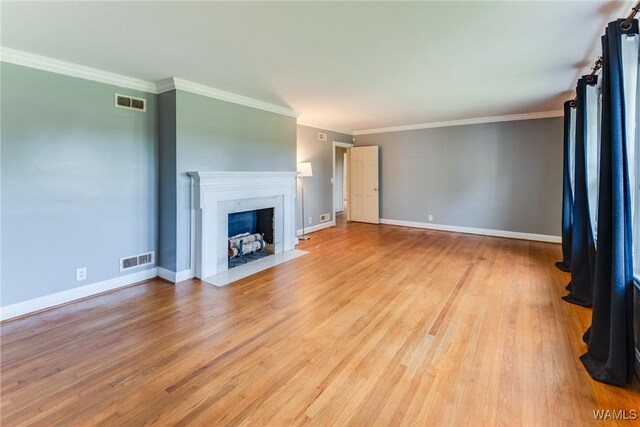 9C Country Club Hls, Tuscaloosa, AL 35401 - unfurnished living room featuring crown molding, light wood-type flooring, a fireplace with flush hearth, and baseboards