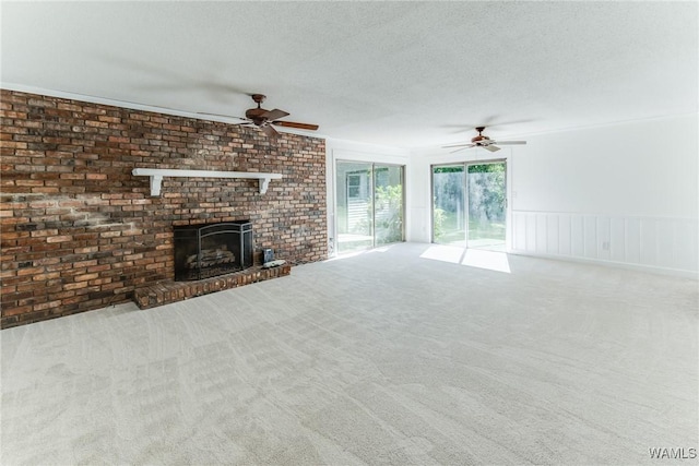 9C Country Club Hls, Tuscaloosa, AL 35401 - unfurnished living room featuring a ceiling fan, carpet, a textured ceiling, and a fireplace