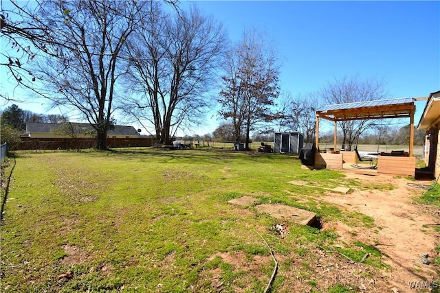 view of yard featuring fence and an outdoor structure