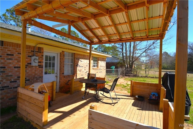 wooden terrace featuring fence