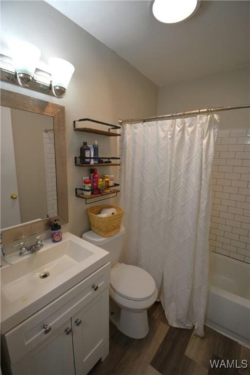 full bath with toilet, shower / bath combo, wood finished floors, and vanity