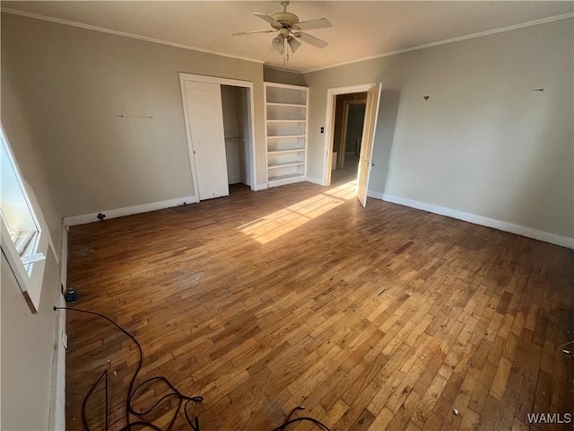 unfurnished bedroom with baseboards, ornamental molding, and hardwood / wood-style floors