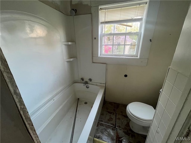 bathroom with toilet and shower / tub combination