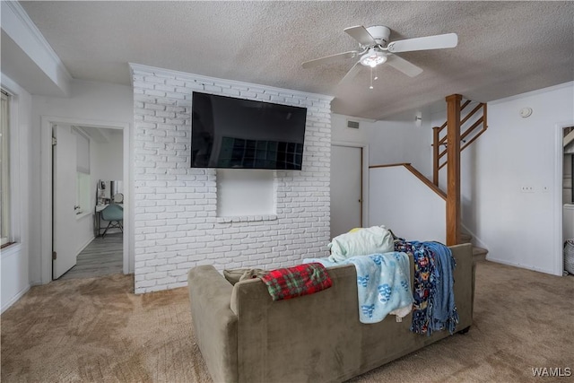 living room featuring ceiling fan, carpet, and a textured ceiling