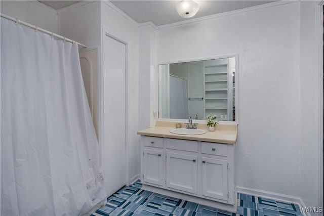 bathroom featuring crown molding, a textured ceiling, and vanity