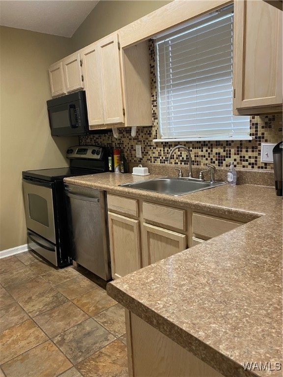 kitchen featuring appliances with stainless steel finishes, backsplash, light brown cabinetry, sink, and lofted ceiling