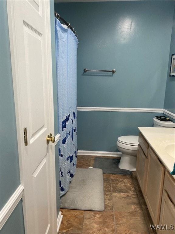 bathroom featuring vanity and toilet