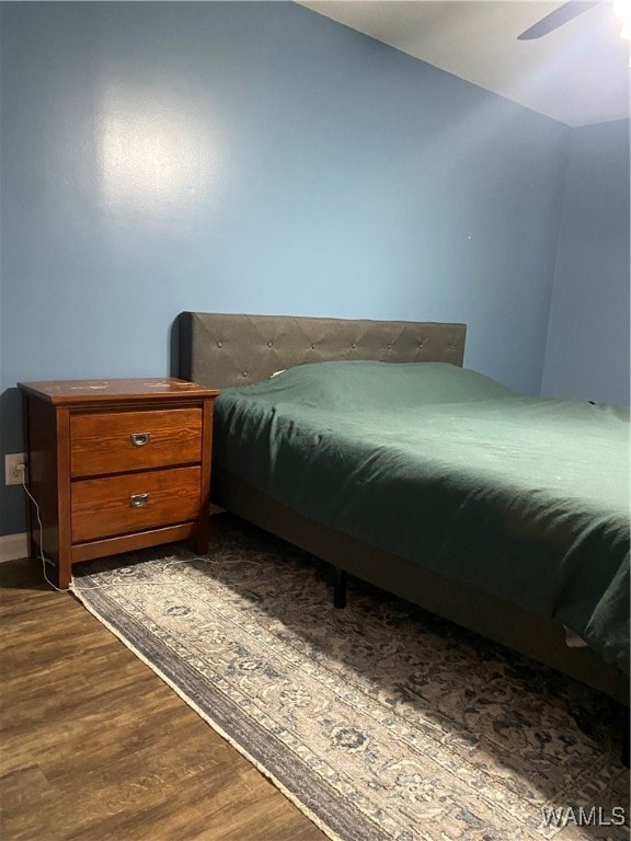 bedroom with ceiling fan and hardwood / wood-style flooring