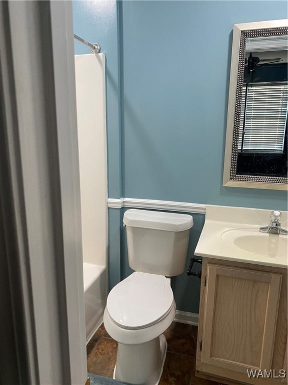 bathroom with tile patterned flooring, vanity, and toilet