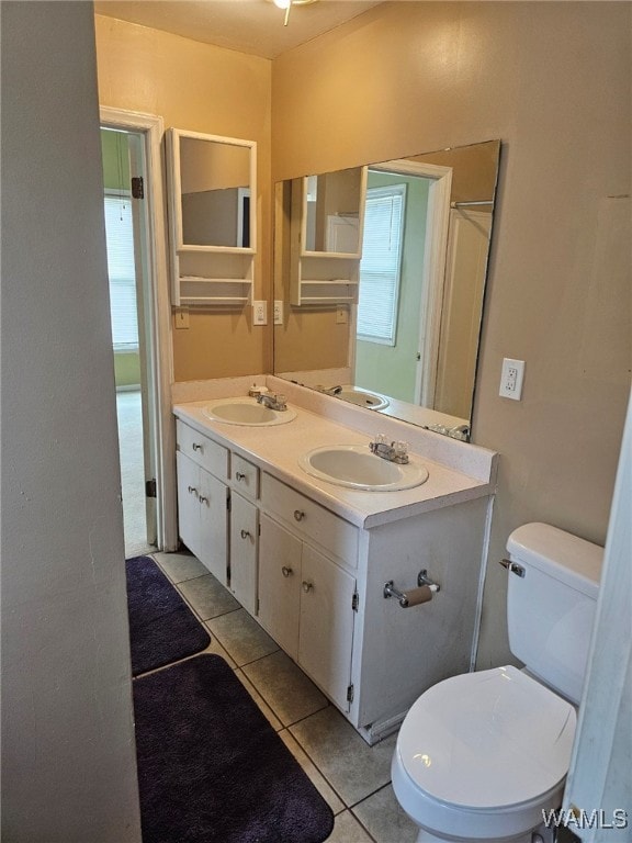 bathroom featuring tile patterned flooring, vanity, and toilet