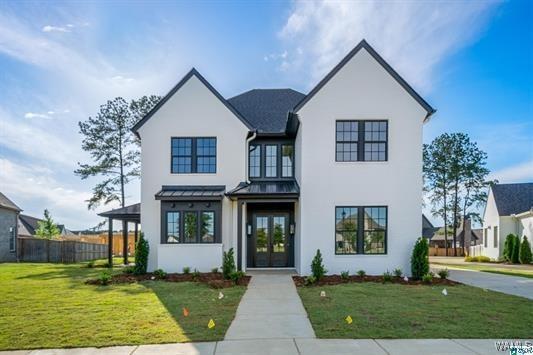 5930 Carleton Park Cir, Tuscaloosa, AL 35406 - modern farmhouse featuring metal roof, fence, a standing seam roof, a front lawn, and stucco siding