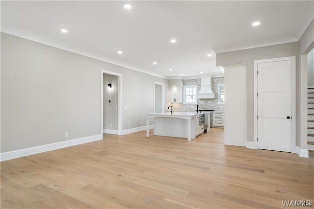 5930 Carleton Park Cir, Tuscaloosa, AL 35406 - unfurnished living room featuring recessed lighting, ornamental molding, baseboards, a sink, and light wood-style floors