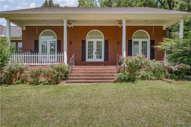 6650 Flatwoods Rd, Northport, AL 35473 - view of front of property with french doors, covered porch, brick siding, and a front yard