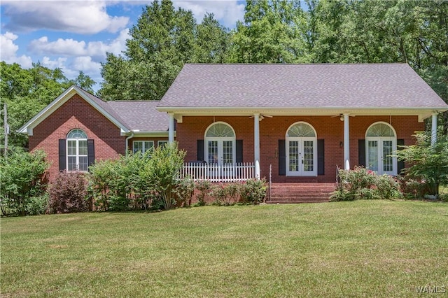 6650 Flatwoods Rd, Northport, AL 35473 - view of front of property featuring french doors, brick siding, and a front yard