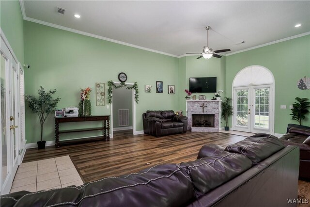 6650 Flatwoods Rd, Northport, AL 35473 - living room featuring a ceiling fan, ornamental molding, a brick fireplace, wood finished floors, and baseboards