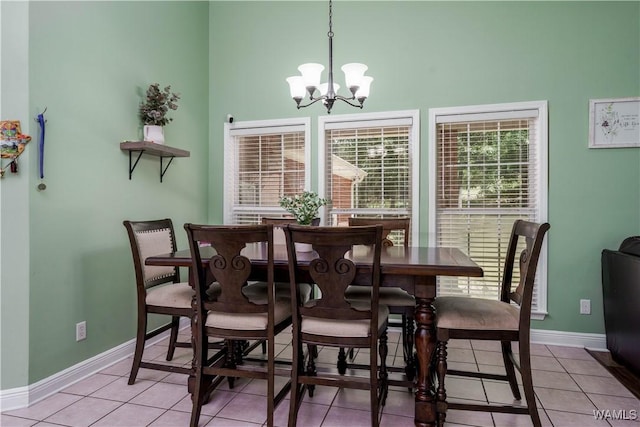 6650 Flatwoods Rd, Northport, AL 35473 - dining area with baseboards, light tile patterned floors, a chandelier, and a high ceiling