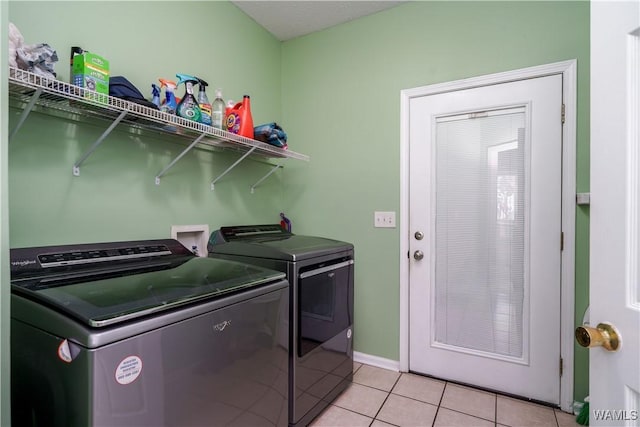 6650 Flatwoods Rd, Northport, AL 35473 - laundry room featuring separate washer and dryer, light tile patterned flooring, and baseboards