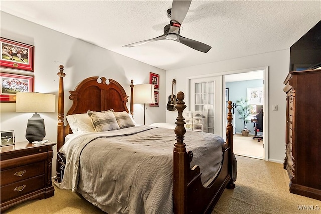 carpeted bedroom featuring a textured ceiling and ceiling fan