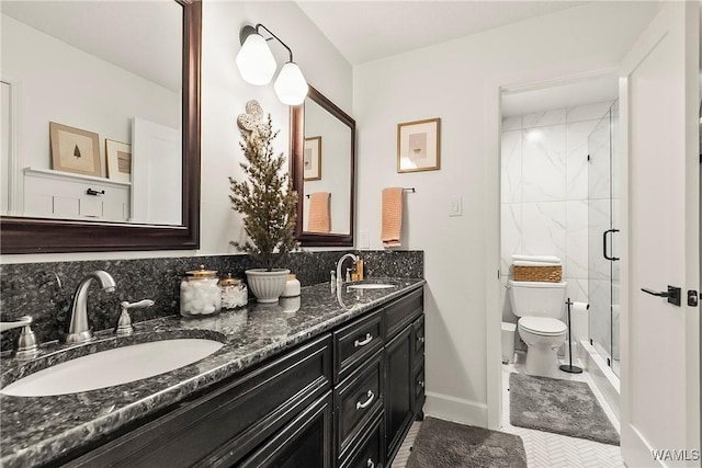 bathroom with an enclosed shower, vanity, and toilet