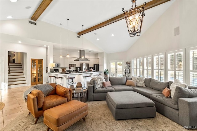 tiled living room with high vaulted ceiling, a notable chandelier, beam ceiling, and french doors