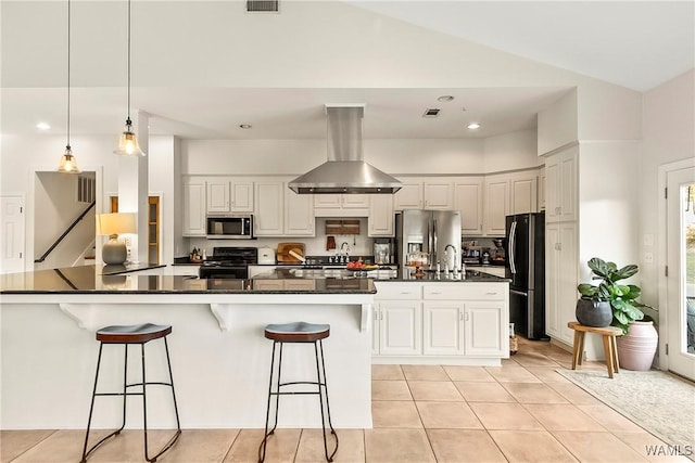 kitchen featuring white cabinets, appliances with stainless steel finishes, a kitchen breakfast bar, and island range hood