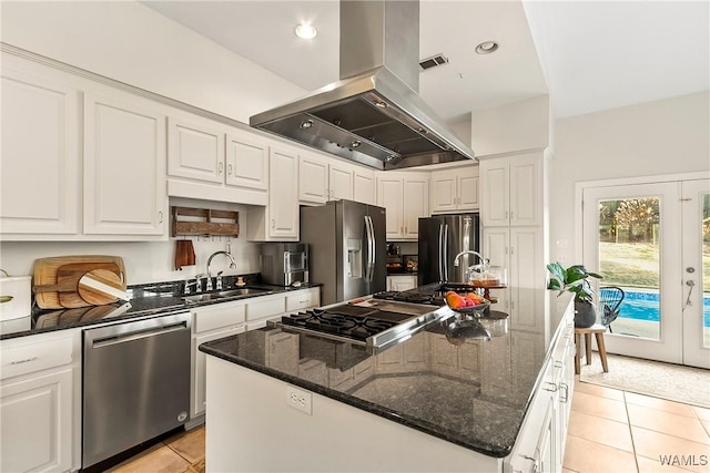 kitchen featuring island range hood, stainless steel appliances, a center island with sink, and light tile patterned floors