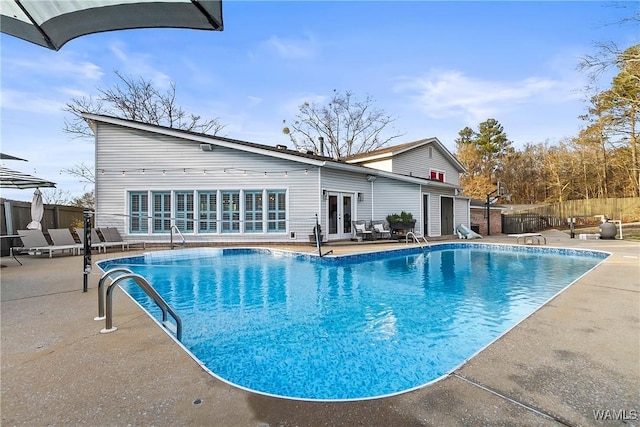 view of pool featuring french doors and a patio area