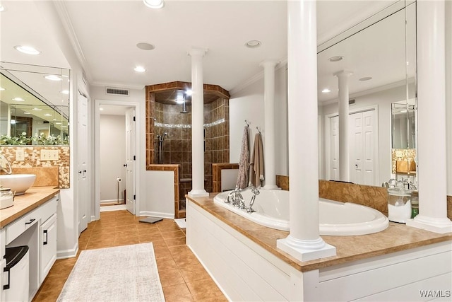 bathroom featuring decorative columns, independent shower and bath, vanity, ornamental molding, and tile patterned floors