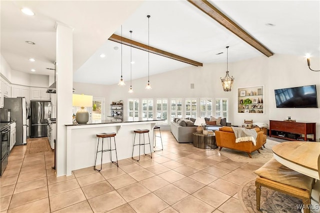 tiled living room featuring an inviting chandelier, beam ceiling, and high vaulted ceiling