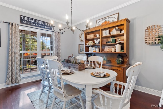 dining space featuring crown molding, dark hardwood / wood-style flooring, and an inviting chandelier