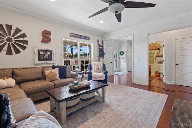 living room with hardwood / wood-style floors, ceiling fan, and crown molding