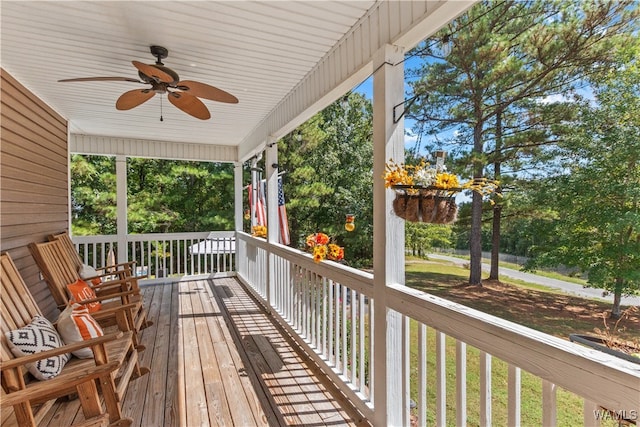 wooden deck featuring ceiling fan and covered porch