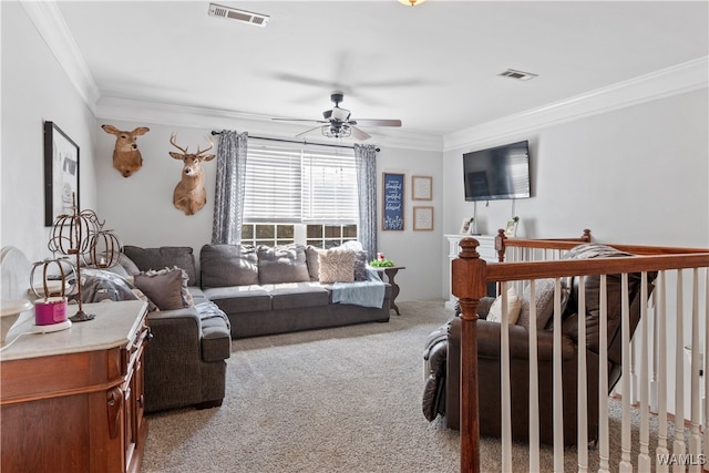 carpeted living room featuring crown molding and ceiling fan