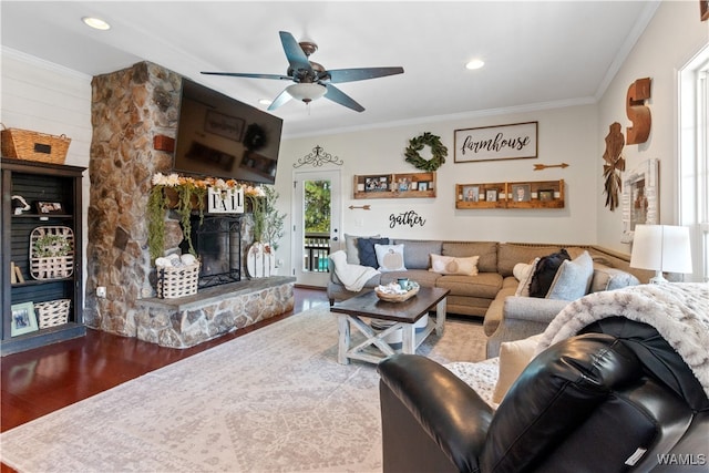 living room with a fireplace, hardwood / wood-style floors, plenty of natural light, and ornamental molding