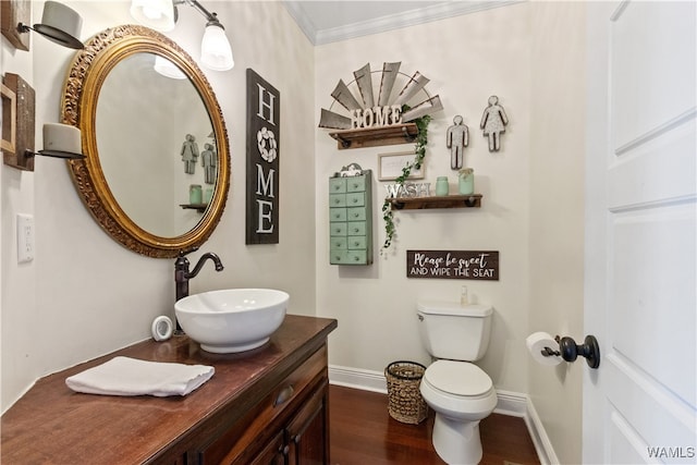 bathroom with hardwood / wood-style flooring, vanity, toilet, and crown molding