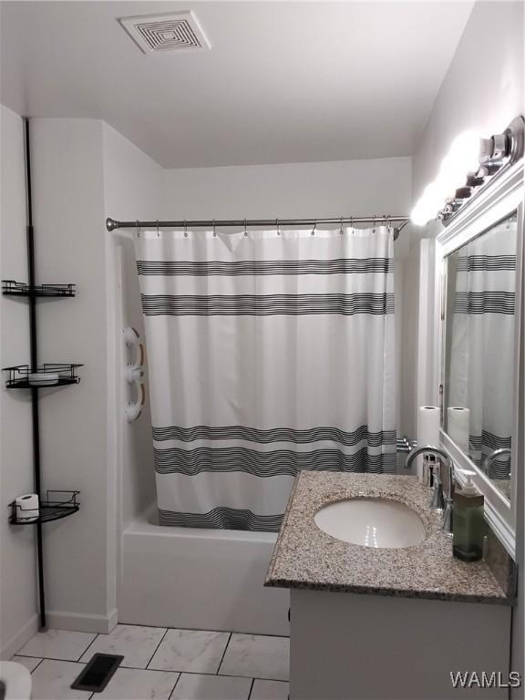 bathroom featuring vanity and shower / tub combo