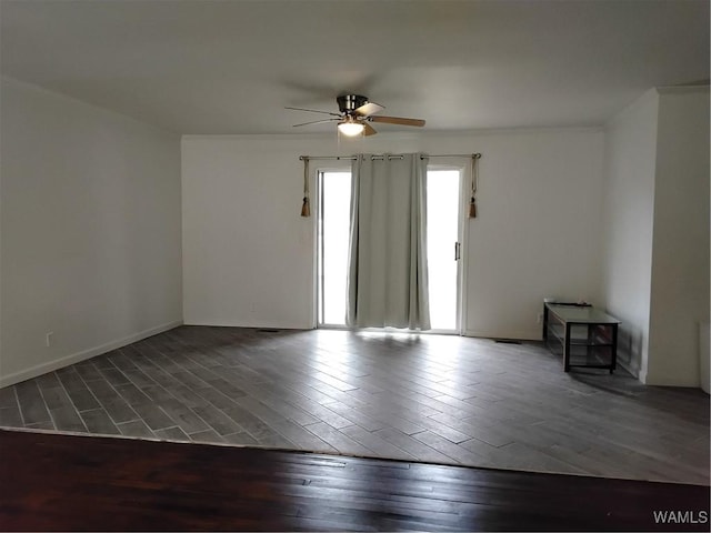 empty room with dark wood-type flooring and ceiling fan