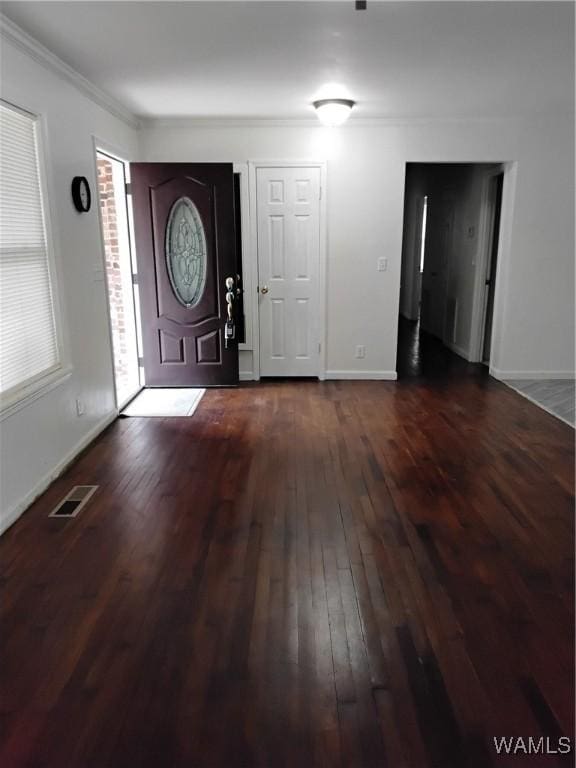 entrance foyer featuring crown molding and dark hardwood / wood-style flooring