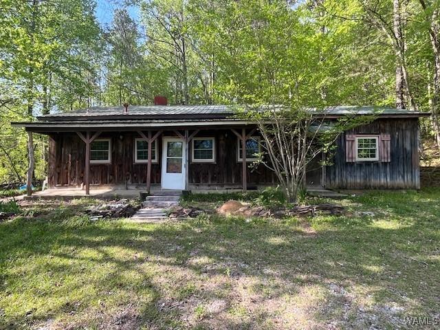 view of front of home featuring a porch and a front lawn