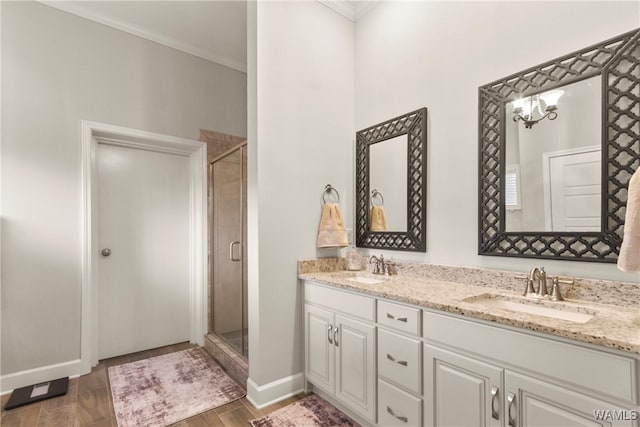 bathroom with vanity, hardwood / wood-style flooring, walk in shower, and crown molding