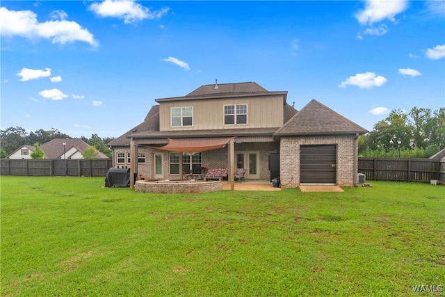 rear view of house with a lawn and a patio